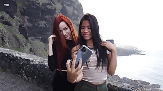 Two beautiful models take a amenable selfie